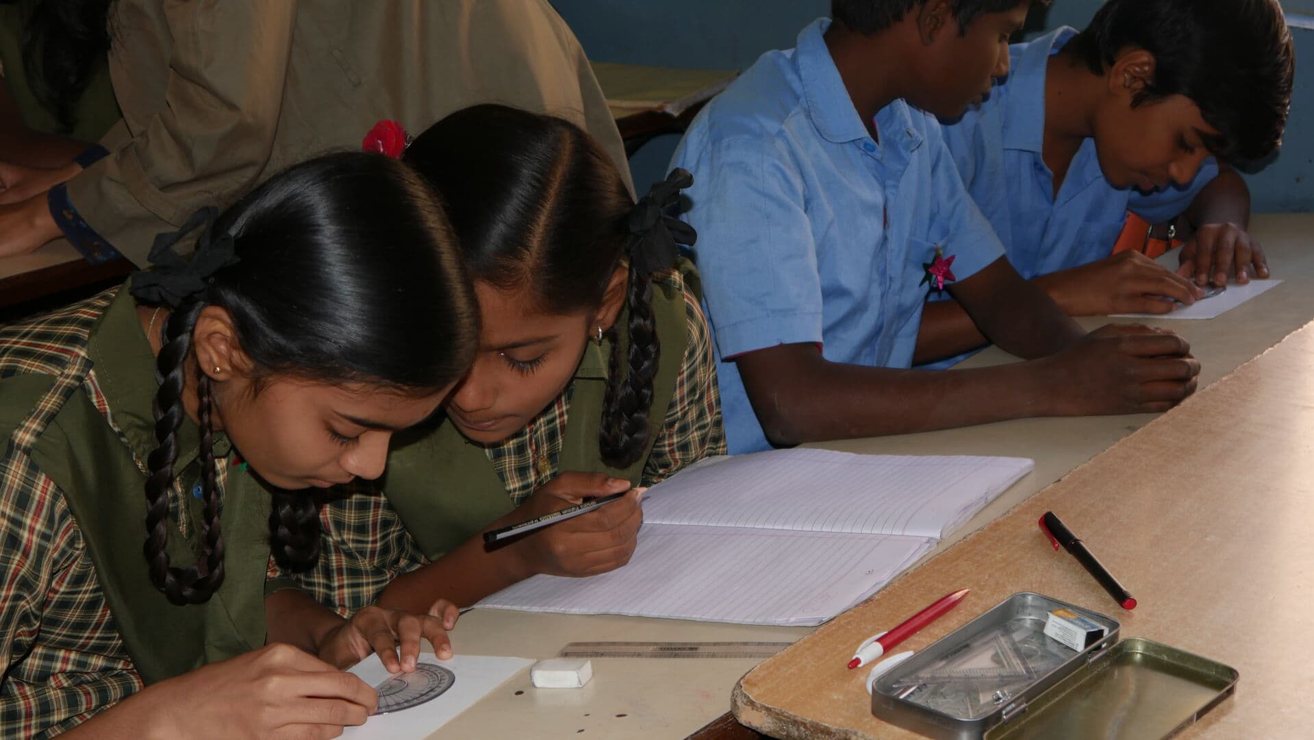 Students concentrating on their schoolwork in a Dream School Foundation classroom